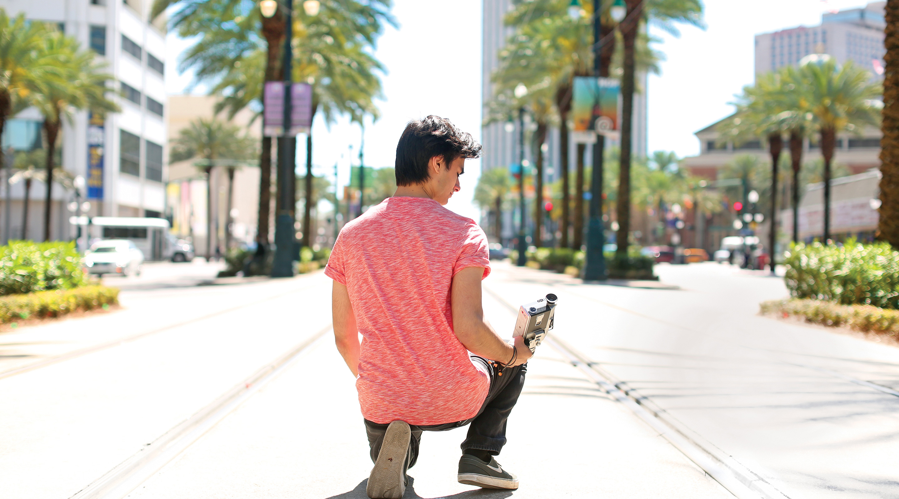 Student with camera on Canal St.