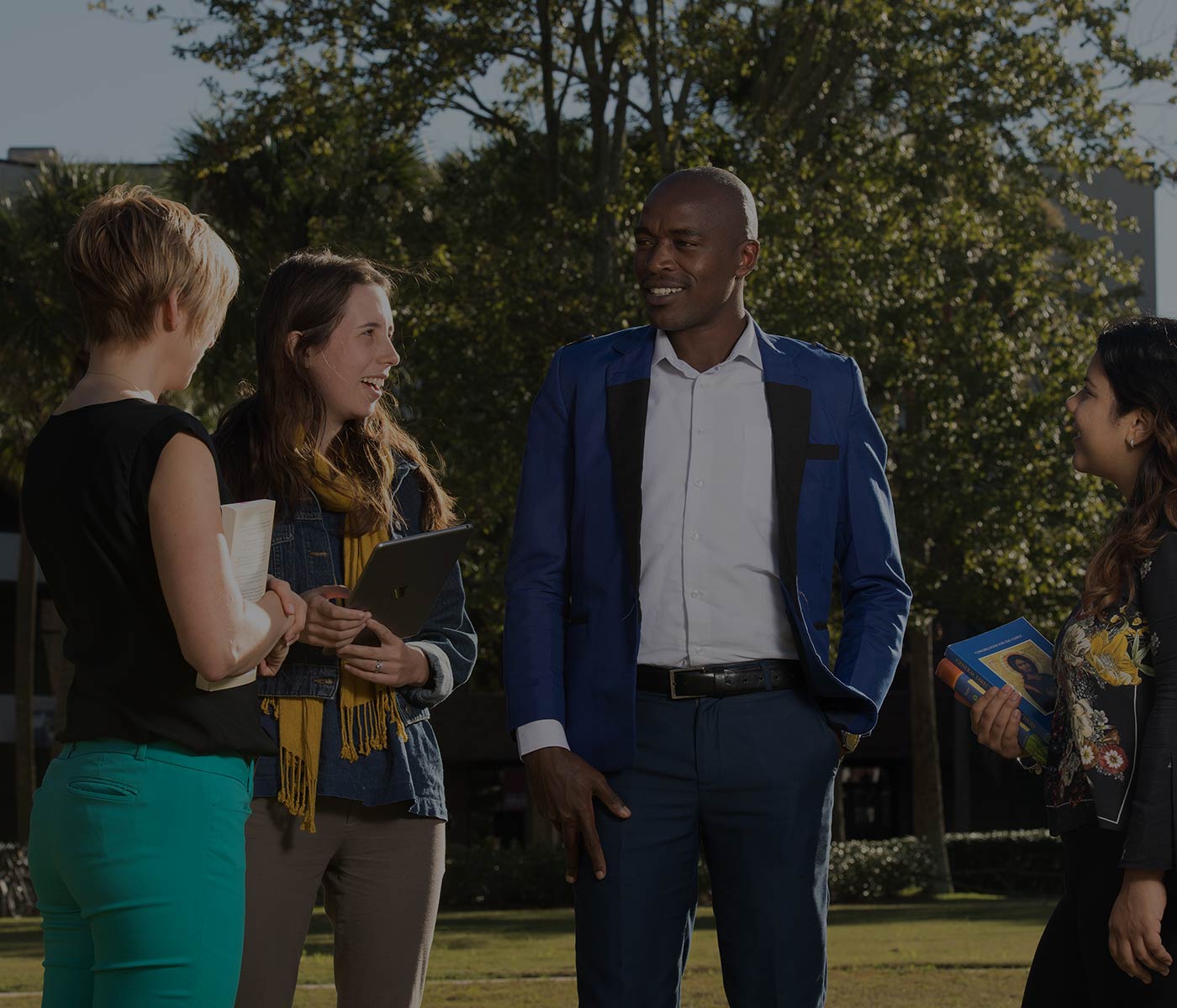 Students and professor talking outside