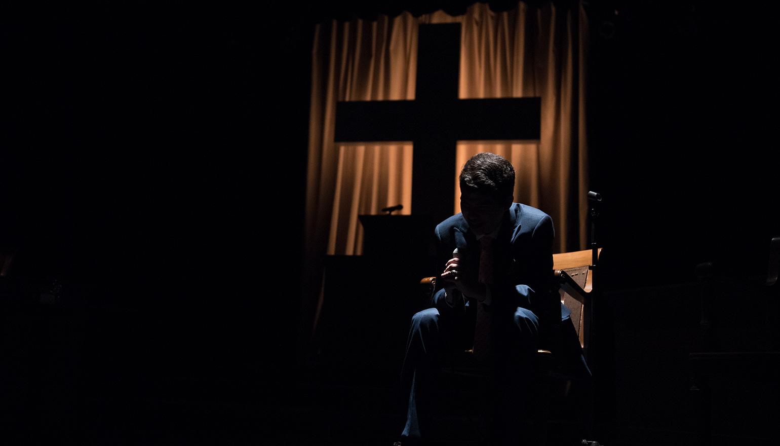 Image of actor with head in hands in The Christians