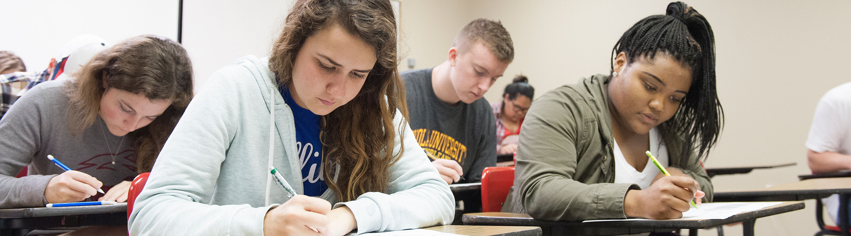High school students taking an exam for college credit