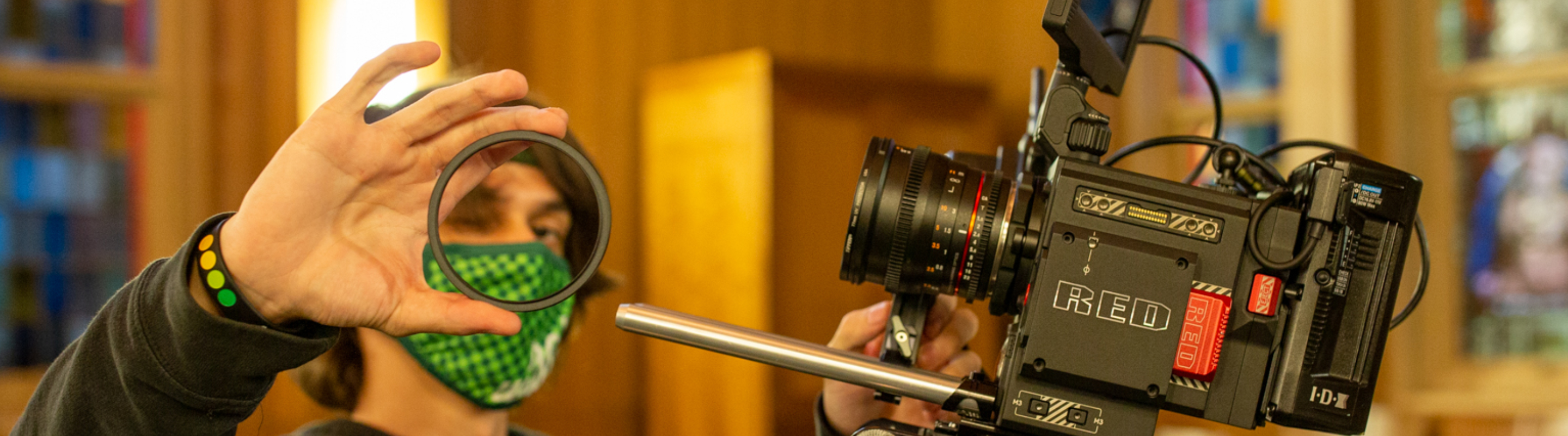 Student putting lens on a RED Camera