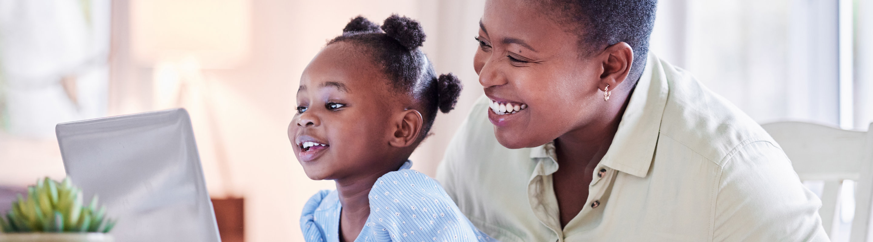 Mom and daughter looking at screen
